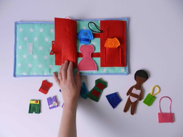 hand-holding-busy-book-on-the-white-table