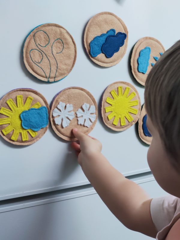 little-boy-showing-snowflake-on-the-fridge